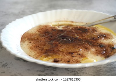 Czech Food: A Traditional Children's Dish - Sweet Semolina Porridge (krupicova Kase) Sprinkled With Cocoa Powder And Melted Butter