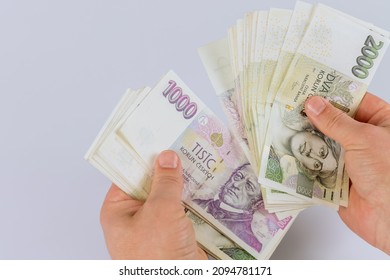 Czech koruna currency banknotes in the hands of a man - Shutterstock ID 2094781171