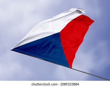 Czech Republic's flag is isolated on a sky background. flag symbols of Czech Republic. close up of a Czech flag waving in the wind.