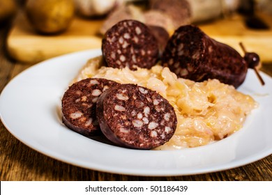 Czech traditional blood sausage  with sauerkraut on white plate