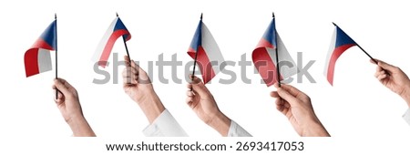 The Czechia flag in hand in different angles on a white background