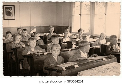 THE CZECHOSLOVAK SOCIALIST REPUBLIC - CIRCA 1950s: Retro Photo Shows Pupils Sit At The Wooden School Desks In The Classroom.