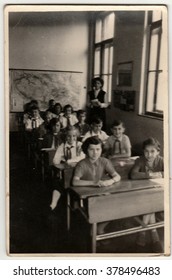 THE CZECHOSLOVAK SOCIALIST REPUBLIC - CIRCA 1960s:  Vintage photo shows pupils sit at the school wooden desk in classroom.