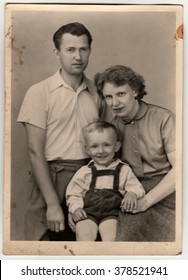 THE CZECHOSLOVAK SOCIALIST REPUBLIC - CIRCA 1960s: A vintage photo shows mother, father and their small son.