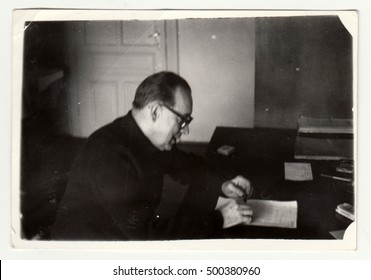 CZECHOSLOVAK SOCIALIST REPUBLIC - CIRCA 1960s: Vintage Photo Shows Man Sits At The Desk. Black & White Retro Photography. 