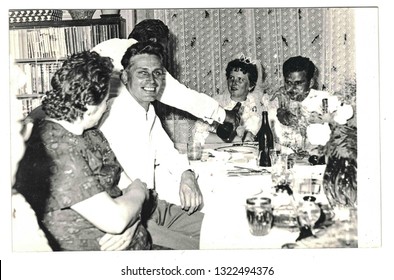 THE CZECHOSLOVAK SOCIALIST REPUBLIC - CIRCA 1970s: Vintage Photo Shows Newlyweds And Wedding Guests Sitting At Wedding Table. Retro Black And White Photography.