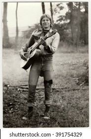 THE CZECHOSLOVAK SOCIALIST REPUBLIC - CIRCA 1980s: Vintage Photo Shows Young Hiker Plays The Guitar Outdoors. Antique Black & White Photo.