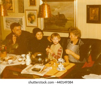 THE CZECHOSLOVAK SOCIALIST REPUBLIC - CIRCA 1980s:  Retro Photo Shows Family During Small Home Party In The Living Room. Vintage Color Photography.