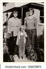 THE CZECHOSLOVAK SOCIALIST REPUBLIC - CIRCA 1980s: Vintage Photo Shows Young Girls  And Child In Front Of Country House. Retro Black & White  Photography.