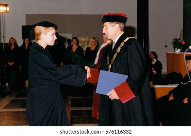 THE CZECHOSLOVAK SOCIALIST REPUBLIC - CIRCA 1980s: Retro Photo Shows  Degree Ceremony. A Chancellor Congratulates Student On Degree Graduation.  Vintage Color Photography.