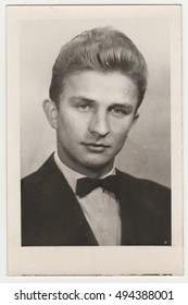 THE CZECHOSLOVAK SOCIALIST REPUBLIC - DECEMBER 20, 1961: Vintage photo shows a young man. He wears black jacket and bow tie. Studio portrait. Retro black & white  photography.
