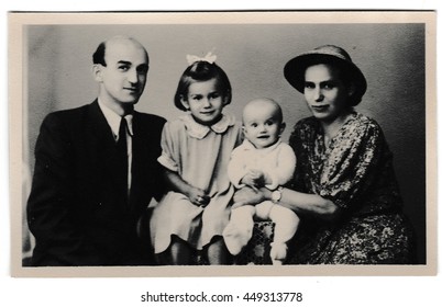 THE CZECHOSLOVAK SOCIALIST REPUBLIC - SEPTEMBER 10, 1947: Retro photo shows Russia family (father, mother and two daughters). Vintage black & white photography.