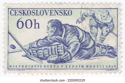 CZECHOSLOVAKIA - 1959 February 14: An 60 Hellers Dark Blue And Pale Green Postage Stamp Showing Ice Hockey Goaltender, Is A Team Sport Played On Ice Skates, Usually On An Ice Skating Rink