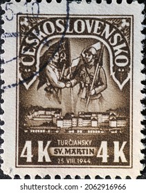 Czechoslovakia Circa 1945: A postage stamp printed in Czechoslovakia showing a soldier with flags Slovak National Uprising, 1st Anniversary. Text: Turčianský Svatý Martin 