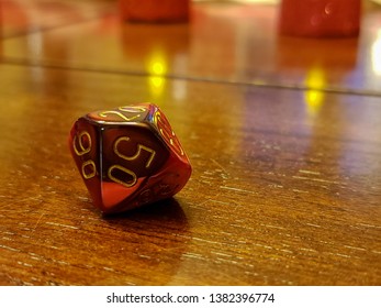 D10 percentile role playing dice isolated on a wooden table. - Shutterstock ID 1382396774