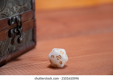 D20 Role Playing White Dice Lie Near Wooden Storage Box, Concept For Playing Role-playing Game On Wooden Background