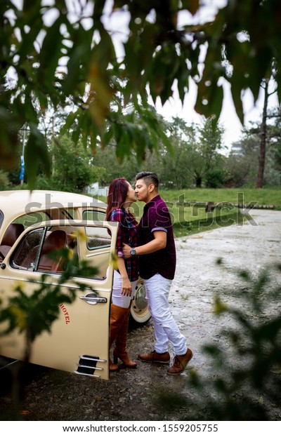 Da Lat city, Viet Nam, 10 Nov 2019: The couple kisses\
on the antique car