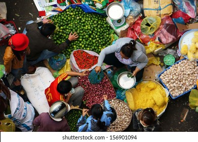 DA LAT, VIET NAM- FEB 8: Crowded atmosphere at outdoor farmers market, people buy vegetable, the colorful overview of fresh vegetable with people at open air market in Dalat, VietNam on Feb 8, 2013