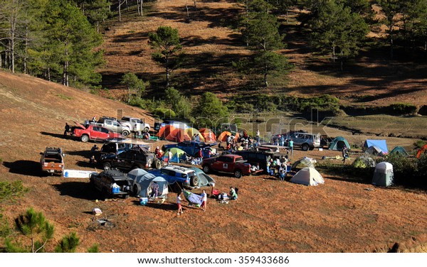 DA LAT, VIET NAM- JAN 2: Group of person  in family\
vacation in spring, people with 4x4 terrain car camp at pine\
forest, exciting experience in eco travel with tent, Dalat,\
Vietnam, Jan 2, 2016