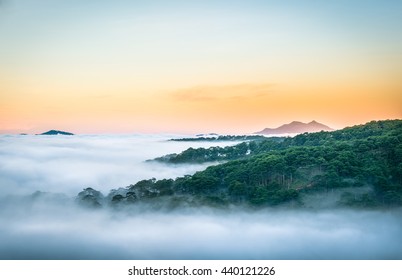 Da Lat, Vietnam, sun rise on mountain in fog - Shutterstock ID 440121226