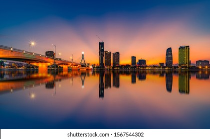Da Nang city, Vietnam ,10 September 2019 :Reflection sunset in Han River with Flowers and Building.Han River with Sail Bridge Dragon Bridge , Han Bridge... are famous places for visit in Danang.
