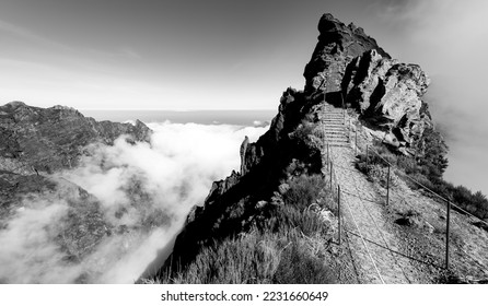 “Ninho da Manta“ panorama near „Pico do Arieiro“ peak, Madeira Island portugal. Narrow mountain ridge with steep precipice both sides the trail. Black and white scenic view on popular hiking path. - Powered by Shutterstock