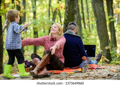 Dad Is Always Busy. Family Day Concept. Family With Kid Boy Relaxing In Forest. Mother And Little Play Together While Father Working With Laptop. Conflicts Of Being Dad. Family And Career Goals.