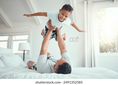 Dad, boy and happy with flying in bed at home for fun to relax, bonding and care in Brazil. People, parent and kid in bedroom with playing for support, child development and childhood memories - Powered by Shutterstock