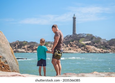 Dad Care Son Near Sea, Walk Spend Time Together Explore New. Man Hold Kid Hand. Lighthouse Background Symbol Of Individual Consciousness, Raising Boy, Father Family Union Influence In Happy Child Live