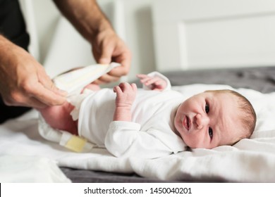 Dad Changing Newborn Baby's Diaper. Closeup, Natural Light, No Retouch.