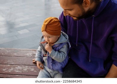 Dad and child are walking in the autumn park. Mediterranean climate. - Shutterstock ID 2258684345