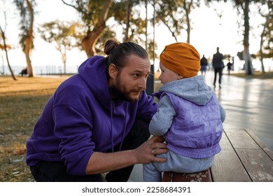 Dad and child are walking in the autumn park. Mediterranean climate. - Shutterstock ID 2258684391