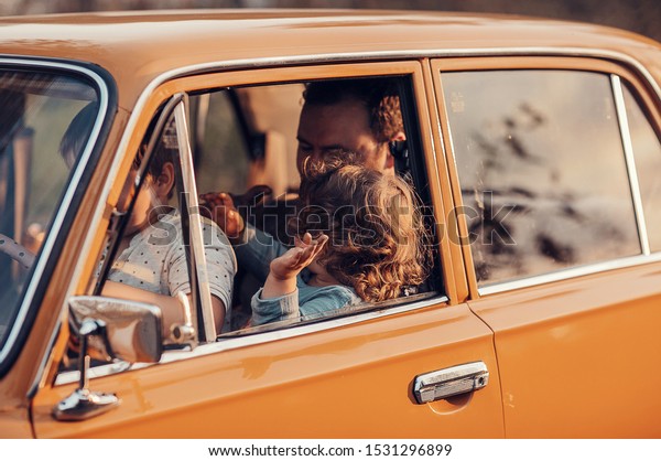 dad with children in the\
car