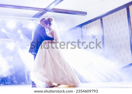 dad and daughter dance in the restaurant hall. hall with light and smoke.