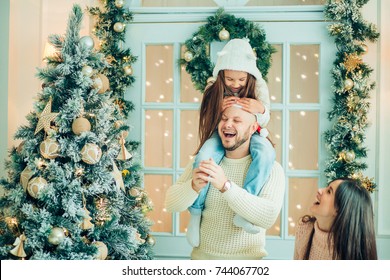 Dad And Daughter Decorate Christmas Tree Indoors. Morning Before Xmas. Portrait Loving Family Close Up.