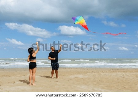 Similar – Image, Stock Photo Flying rainbow kites coast