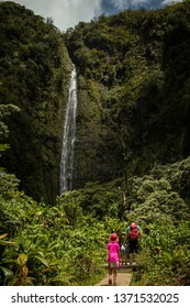 A Dad And Daughter Hike To Waimoku Falls In Haleakala National Park In Maui, Hawaii. This Is The Last Waterfall On The Pipiwai Trail. 