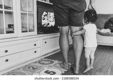 Dad And Daughter Looking TV In The Room Indoor In Home. Happy Family Portrait: Father, Dad Prohibits Girl Watching TV, Concept Of A Family Holiday. Close Up. Black And White Photo.