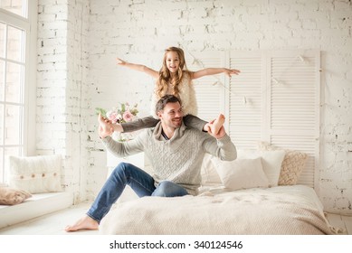 Dad And Daughter Playing And Laughing In Bed, Happy Family