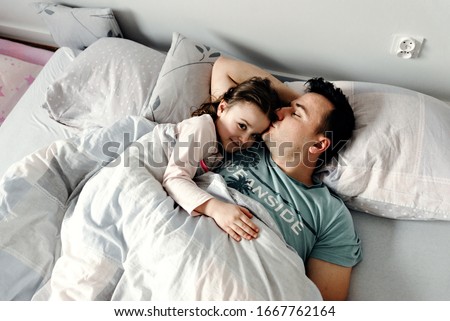 Similar – Little girl playing with boy over the bed