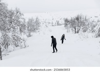 Dad and daughter walk through the winter forest, snowy landscape and outdoor activities - Powered by Shutterstock