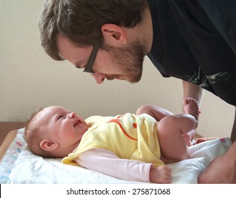 Dad Is Going To Change A Diaper To His Small Smiling Baby, Selective Focus