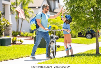 dad guiding his son first bike ride. dad and son enjoying fun bike outing. dad and son on biking adventure. Family bike outing. dad and son duo pedaling through picturesque landscape - Powered by Shutterstock