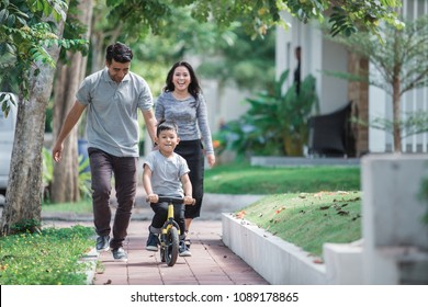 Dad Help His Son Learning To Ride A Bike Using Balance Or Push Bikecycle