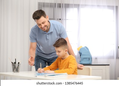 Dad Helping His Son With Homework In Room, Space For Text