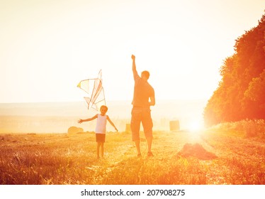 Dad with his little daughter let a kite in a field