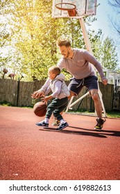 Dad And His Son Playing Basketball.