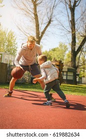 Dad And His Son Playing Basketball.