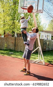 Dad And His Son Playing Basketball.