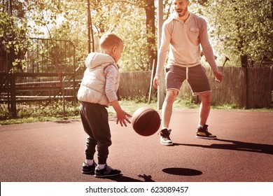 Dad And His Son Playing Basketball.